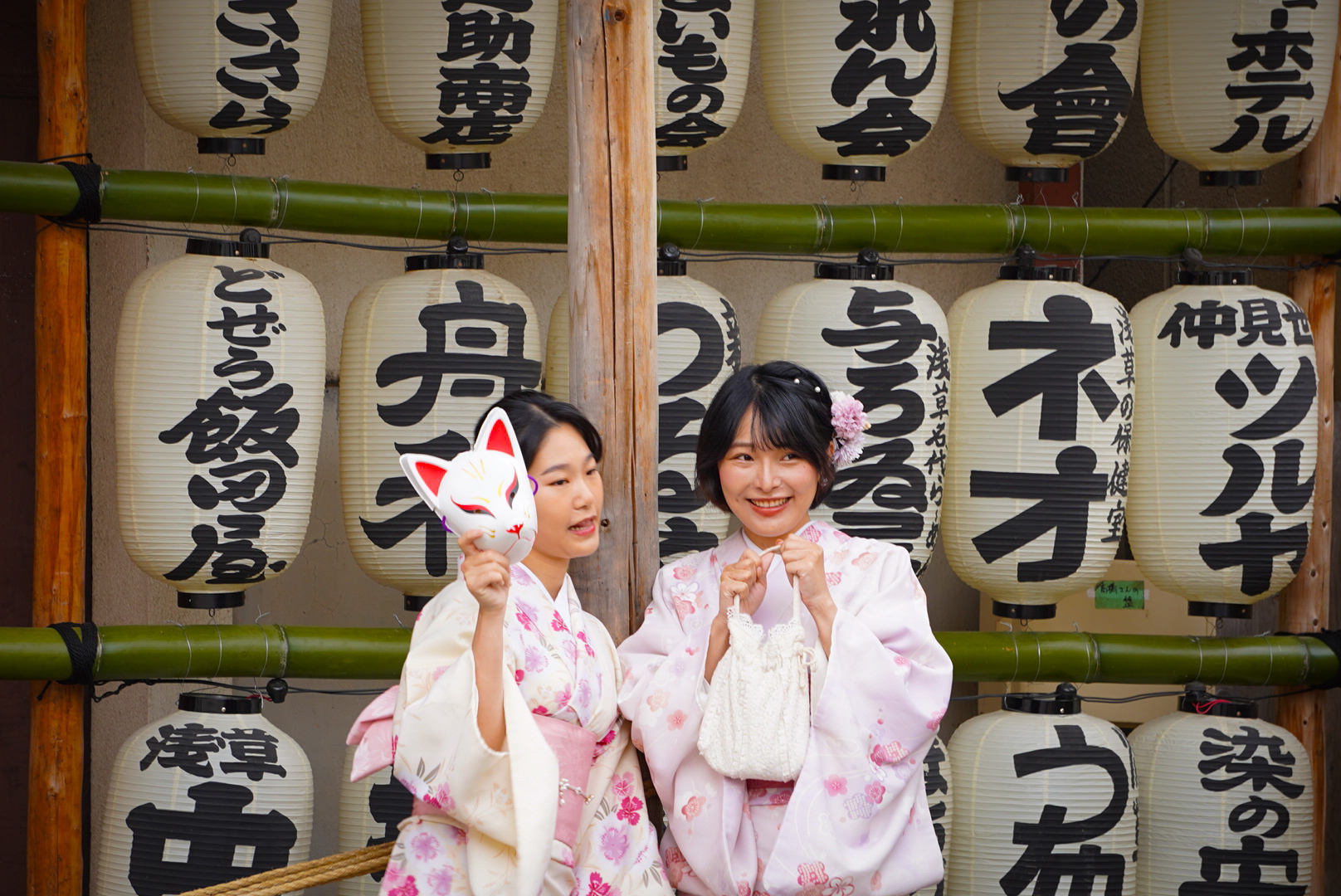 mujeres japonesas vistiendo kimono con lamparas tradicionales de fondo