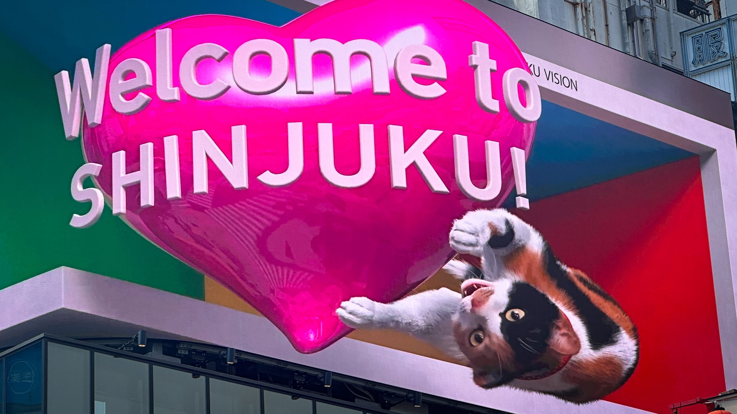 Cartel de gato 3d en shinjuku con un texto que dice bienvenidos